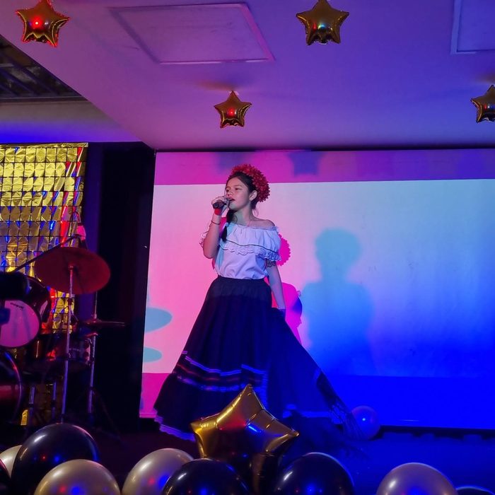 A student singing on the school stage